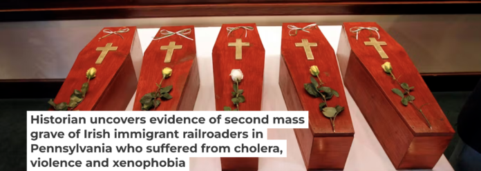 Caskets of Irish railroaders whose remains were excavated from a mass grave outside Philadelphia. AP Photo/Matt Rourke